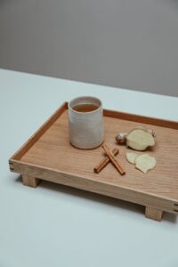 herbal teas like this cup of ginger tea on a bamboo tray can help balance seasonal affective disorder